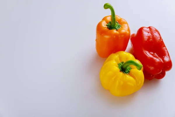 Sweet red, yellow and red bell pepper on white isolated background. Copy space.