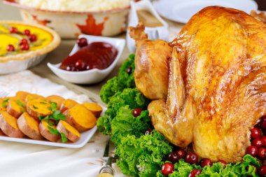 Lahana ve kızılcıkla süslenmiş hindi ile servis edilen şenlikli yemek masası. Noel tatili ya da Şükran Günü konsepti.