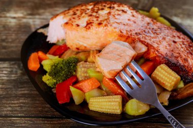 Pişmiş somon fileto ve buğulanmış sebze. Keto diyeti. Kapat..