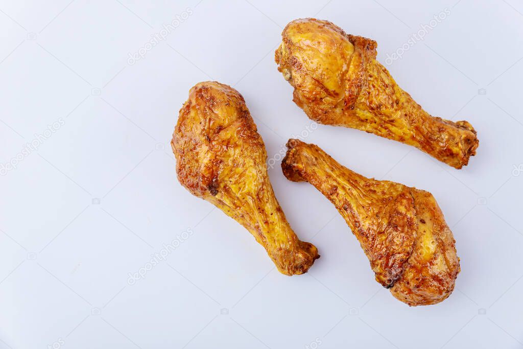 Roasted chicken drumsticks marinated with buffalo sauce isolated on white background. Top view.