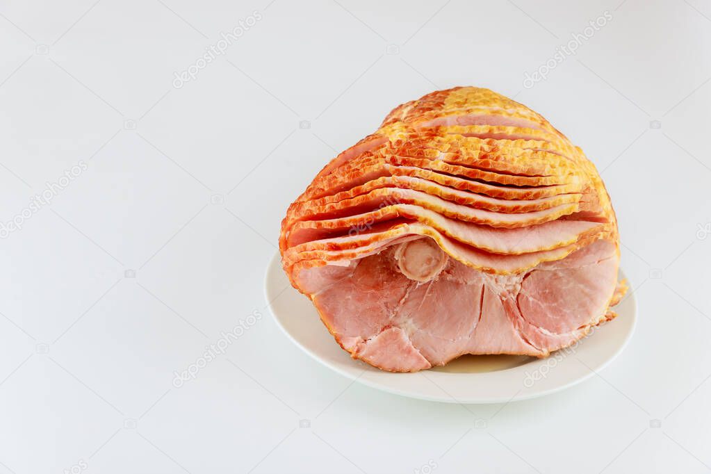Whole spiral sliced hickory smoked pork ham isolated on white background.