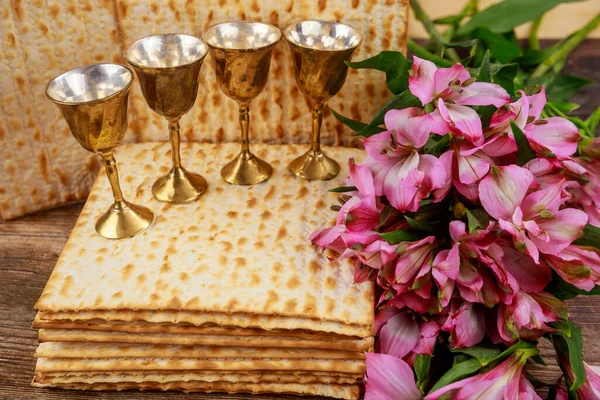 Four cups full of wine with matzah. Jewish holidays Passover concept.