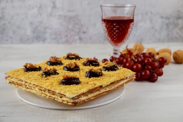 Matzo cake with glass kiddush cup and walnuts. Passover holiday.