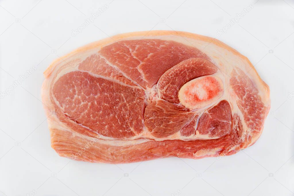 Sliced raw pork shoulder with skin on white isolated background. Top view.