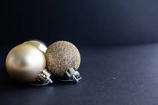 Christmas yellow gold ornaments with black background. Christmas balls. 2020 Merry christmas