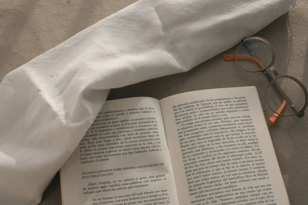 Bir fincan kahve, kitap ve bardaklar gün batımında.