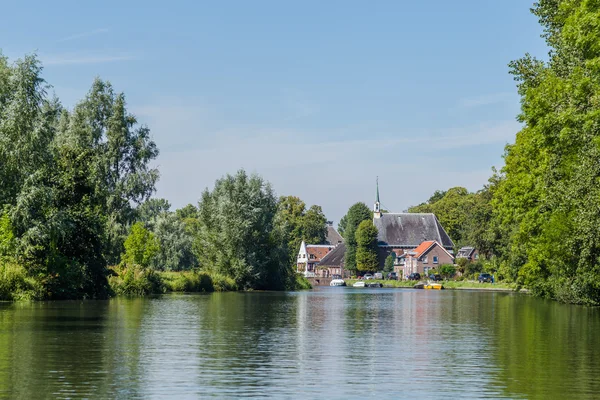 Boating on the river Vecht along the church of Zuilen near Utrec — Stock Photo, Image