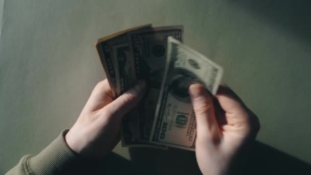 The appearance of male hands on a green background with dollars — Stok video