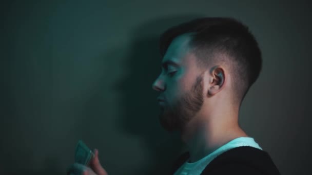 Young man holding an impressive amount of dollar bills in his hands — Stock Video