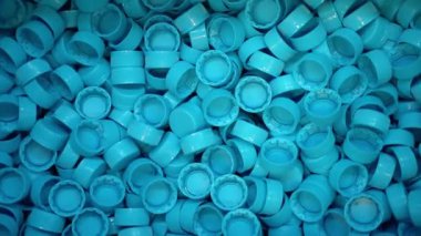 Saf kaynak suyu şişeleme tesisinde çok sayıda plastik şişe kapağı