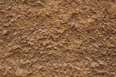 Eskimiş sarı kahverengi alçı duvar dokusu.