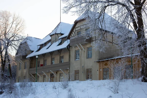 Old mansion palace building of a historical hotel and concert hall in Klaipeda city. Cold winter day and snowy but sunny weather.