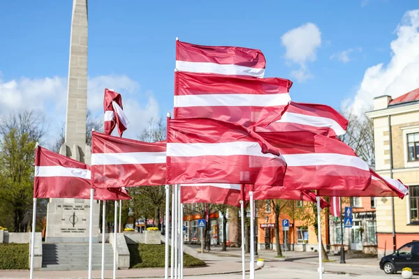 Multiple Latvia flags waving in wind. Photo taken in Europe.