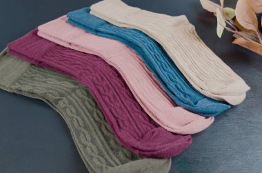 Koyu tahta arka planda farklı renkte kadın çorapları. Bir sürü çorap..