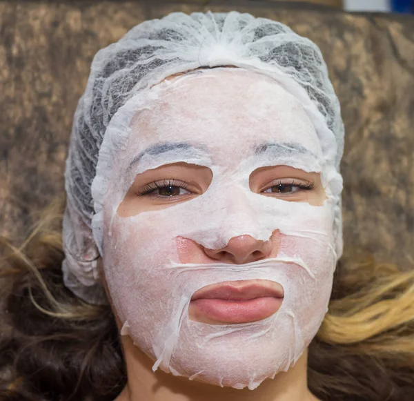 Skin care cosmetic. A woman in a beauty salon during a facial skin care treatment