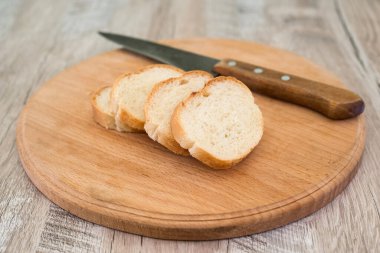 Bıçaklı bir baget ve eski bir tahta kesme tahtasıyla..