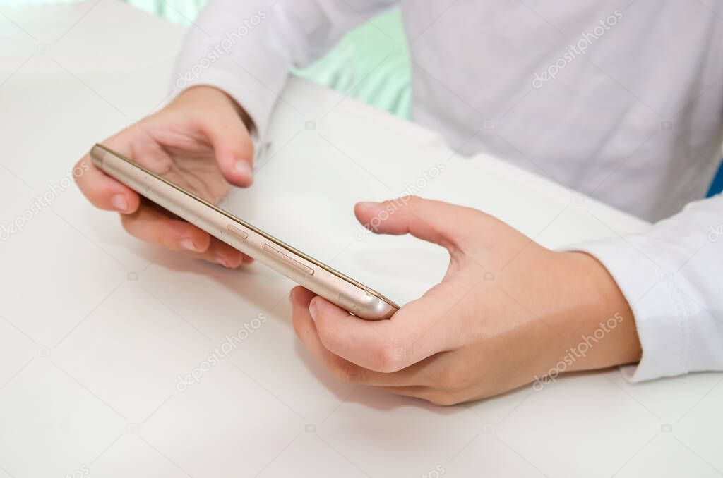 Close up of hands holding playing game on smartphone