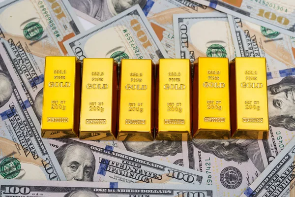 gold bars on 100 new US dollar banknotes. business and finance concept