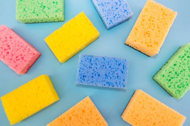 washcloths color on a blue background. View from above. Kitchen sponges for washing dishes, background.