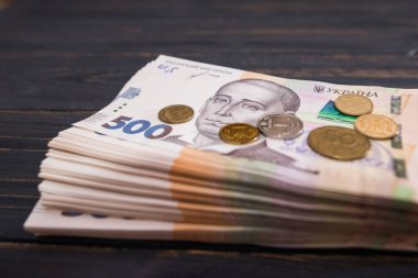 Ukrayna Hryvnia 'sı, ahşap arka planda bozuk paraları olan 500 Hryvnia senedi.
