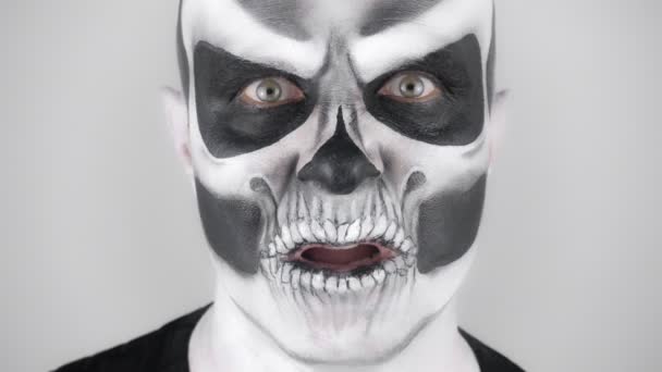 Man Horrible Halloween Skeleton Makeup Trying Scare Shooting Studio Gray — Stock Video