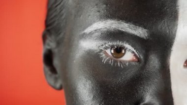 Siyah beyaz makyajlı genç bir kadın kameraya bakıyor. Parlak renkli arka plan. - Evet. Yüksek kalite 4k görüntü