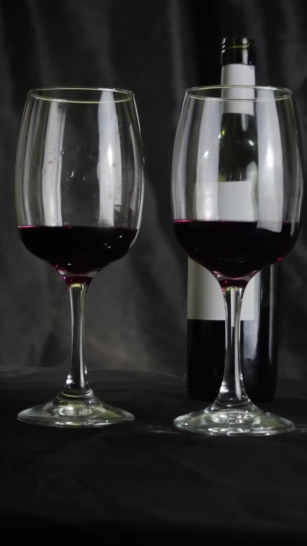 Dos Copas Vino Tinto Una Botella Están Sobre Mesa Fondo — Vídeo de stock