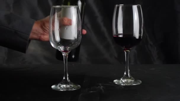 Man Giet Rode Wijn Een Glas Zwarte Achtergrond Langzame Beweging — Stockvideo