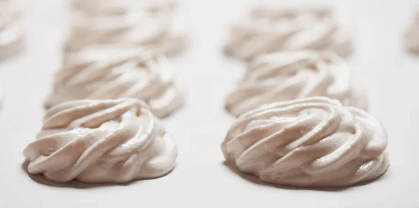 Cooked homemade meringue cookies on baking paper — Stock Photo, Image