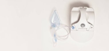 White compressor inhaler with mask on white background, stock photo