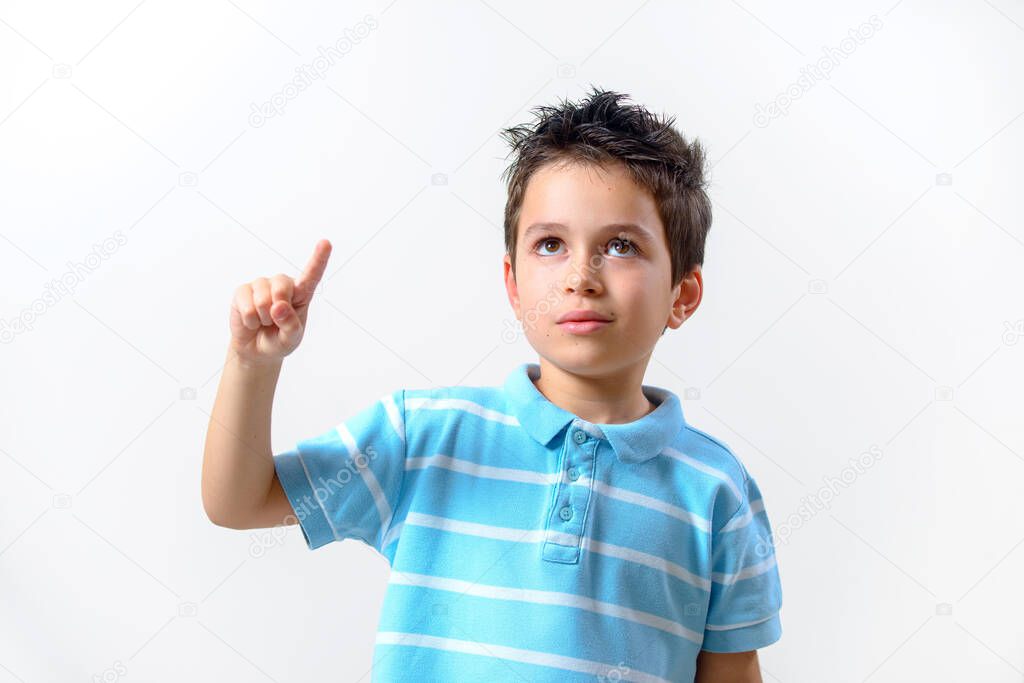 The boy in a blue T-shirt with a brooding face raised his finger up.
