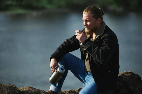 An adventurer having a rest enjoying beautiful nature