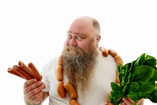 Obese Man Looking Sausages Holding Spinach Other Hand Try Choose — Stock Photo, Image