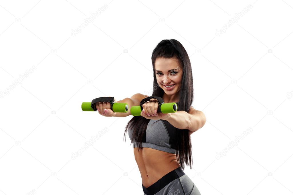 Attractive young sporty woman working out with dumbbells