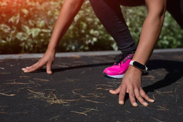 Runner start position. Closeup of woman runner's hands on start position. Jogging