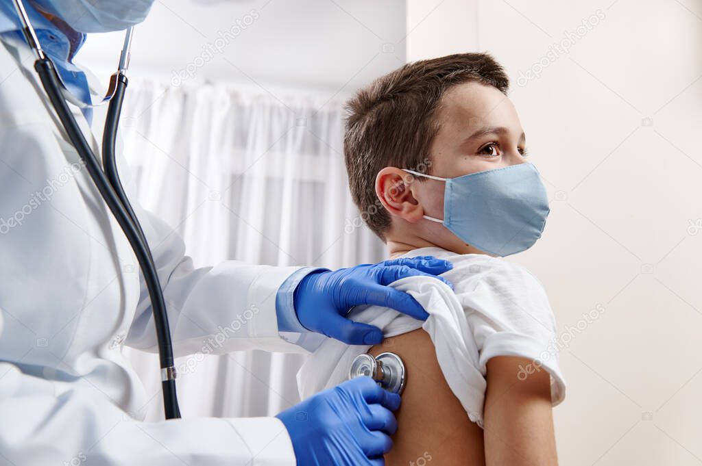 Female doctor pediatrician using stethoscope, checking up heartbeat and lungs while auscultation in doctor office at hospital.