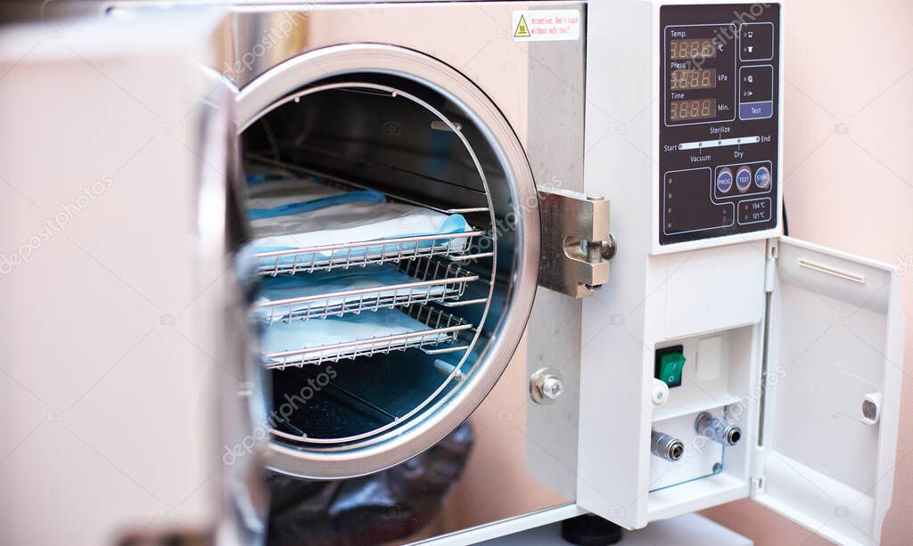 Autoclave sterilization in dentistry . Modern laboratory autoclave sterilizer for cleaning dental tools in dentistry sterilization department