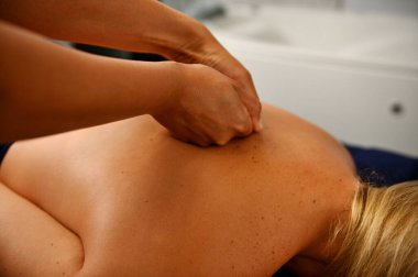 Back massage in the spa salon. Muscle recovery after exercise. The masseur doing a back massage. Sports massage