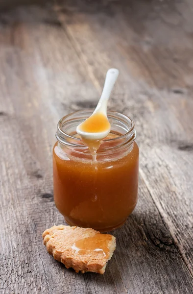 Caramel sauce in glass jar — Stok fotoğraf