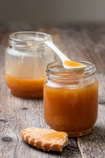 Caramel sauce in glass jars — Stok fotoğraf