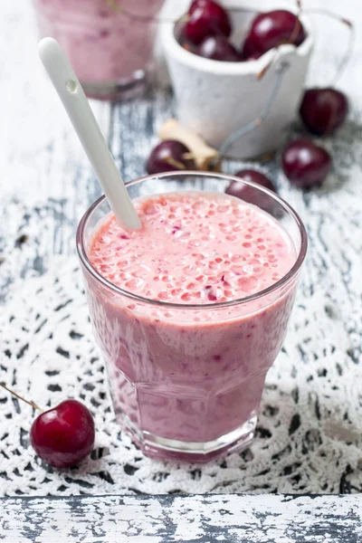 Smoothie with cherries on a wooden background — Stok fotoğraf