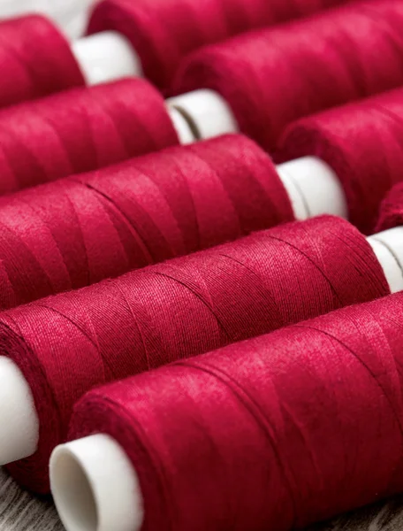 Ranks of red  spools — Stock Photo, Image