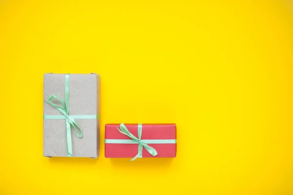 wrapped boxes with gifts on a yellow background