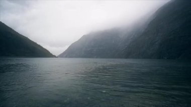Norwegian fjords and mountains. Misty shore and waves. May 2013