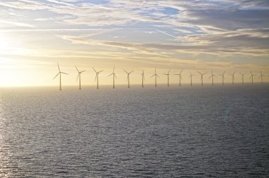 Middelgrunden: an offshore wind farm at dawn. Sunrise over the Sea