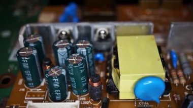 Movement of a view from left to right along the capacitors and transistors. Close-up of the electronic components