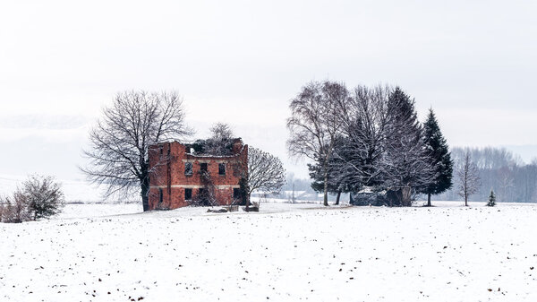 snow covering an abandoned farm