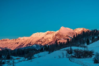 Slovenya ile İtalya arasındaki dağlarda gün batımında dondurucu bir kış günü