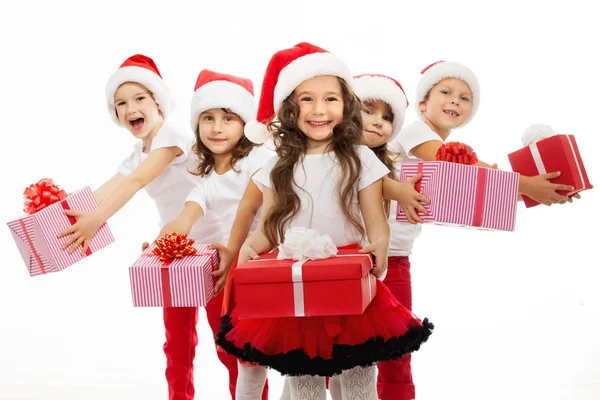 Group of happy kids in Christmas hat with presents — Stock Photo, Image