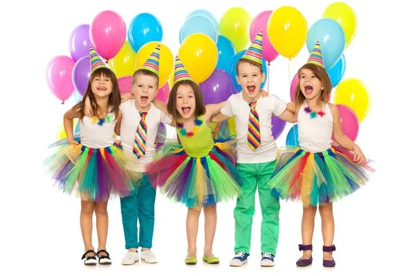 Group of joyful little kids having fun at birthday party — Stock Photo, Image